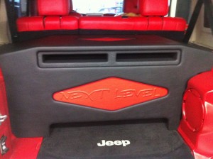 Two MMats Pro Audio Monster 12" subwoofers installed in a custom box in a four door Jeep Wrangler.
