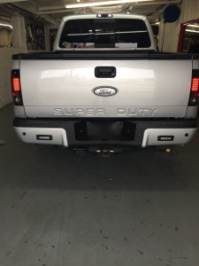 Custom Painted Ford emblems, color matched bumper, Recon Tailights and rigid SR series LED back up lights installed on a F-250.