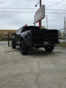 Next Level Edition Ford Raptor with color matched bumper and Rhino Lined trim and Rigid Industries SR series flush mount reverse lights.